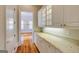 Hallway with white cabinets, granite countertop, and hardwood flooring at 3786 Turnberry Ct, Duluth, GA 30096