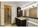 This bathroom offers a vanity sink with storage, granite counters, and a glass shower at 3786 Turnberry Ct, Duluth, GA 30096