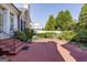 Brick patio with iron railing and steps leading to a landscaped yard at 3786 Turnberry Ct, Duluth, GA 30096