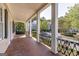 Charming porch with brick flooring, decorative railings, and classic columns at 3786 Turnberry Ct, Duluth, GA 30096