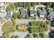 Aerial view of a neighborhood with manicured lawns, mature trees, and swimming pools at 3786 Turnberry Ct, Duluth, GA 30096