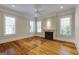 Living room with hardwood floors, a decorative ceiling fan, a fireplace, and lots of natural light at 3786 Turnberry Ct, Duluth, GA 30096