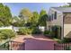 Backyard brick patio with manicured garden and a white picket fence at 3786 Turnberry Ct, Duluth, GA 30096