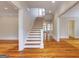 Spacious entryway with hardwood floors and a staircase leading to the upper level at 3786 Turnberry Ct, Duluth, GA 30096