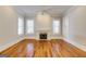 Spacious living room with hardwood floors, fireplace, and large windows for natural light at 3786 Turnberry Ct, Duluth, GA 30096
