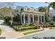 Stately home with a welcoming front porch, lush landscaping, and wrought iron fencing at 3786 Turnberry Ct, Duluth, GA 30096