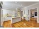 Spacious kitchen with island, white cabinets, modern appliances, and hardwood floors at 3786 Turnberry Ct, Duluth, GA 30096