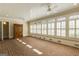 Bright sunroom with brick floor, wood paneled ceiling and windows with white shutters allowing natural light at 3786 Turnberry Ct, Duluth, GA 30096