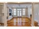 Open living room with hardwood floors, white columns, and built-in cabinets and entertainment center at 3786 Turnberry Ct, Duluth, GA 30096