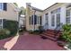 Back patio with brick paving and black iron railing leading to a manicured garden at 3786 Turnberry Ct, Duluth, GA 30096
