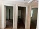 Hallway featuring multiple doorways and worn flooring at 2681 Oldknow Dr, Atlanta, GA 30318