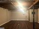 Unfinished basement space with dark wood-look flooring offers plenty of potential at 6740 Davidson Ct, Lithonia, GA 30058