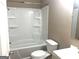 This bathroom features a shower and bathtub combination with tile surround, toilet, and sink at 6740 Davidson Ct, Lithonia, GA 30058