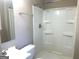 A clean bathroom featuring a shower and bathtub combination, toilet, sink, and a mirror at 6740 Davidson Ct, Lithonia, GA 30058