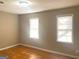 Neutral bedroom with hardwood floors and two bright windows at 6740 Davidson Ct, Lithonia, GA 30058