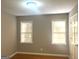Well-lit bedroom with hardwood floors, neutral walls, and two windows for ample natural light at 6740 Davidson Ct, Lithonia, GA 30058