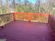 Spacious wooden deck with red painted banister is great for outdoor entertaining at 6740 Davidson Ct, Lithonia, GA 30058
