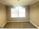 Cozy dining room with plush carpet, soft lighting, and a large window for natural light at 6740 Davidson Ct, Lithonia, GA 30058