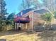 View of the house from the backyard with deck and brick exterior at 6740 Davidson Ct, Lithonia, GA 30058