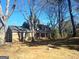 Two-story brick home showcasing a spacious front yard and classic architectural design at 6740 Davidson Ct, Lithonia, GA 30058
