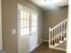 Inviting foyer with a tiled floor, staircase, and a glass-paneled double door entry at 6740 Davidson Ct, Lithonia, GA 30058