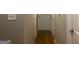Hallway with wood floors, neutral walls, and access to multiple rooms at 6740 Davidson Ct, Lithonia, GA 30058