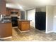 Open-concept kitchen with a central island, black appliances, and wood cabinets at 6740 Davidson Ct, Lithonia, GA 30058