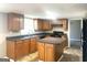 A well-lit kitchen showcasing wooden cabinets, countertop space, and a central island at 6740 Davidson Ct, Lithonia, GA 30058