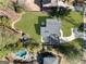 Aerial view of a property featuring a backyard with a pool, patio, and verdant green lawn at 4217 Paces Ferry Se Rd, Atlanta, GA 30339