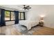 Bright bedroom with large windows, hardwood floors, a ceiling fan, and a stylish rug at 4217 Paces Ferry Se Rd, Atlanta, GA 30339