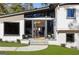 Beautiful entryway featuring a glass front door, large windows, and manicured landscaping at 4217 Paces Ferry Se Rd, Atlanta, GA 30339