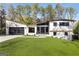 Contemporary home featuring a lush front lawn, dark framed windows, and a two-car garage at 4217 Paces Ferry Se Rd, Atlanta, GA 30339