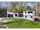 Charming home with a well-maintained lawn, sleek garage doors, and contemporary design elements at 4217 Paces Ferry Se Rd, Atlanta, GA 30339