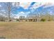 Backyard view of the house featuring a pool, mature trees, patio and screened porch at 240 Sandy Lake Cir, Fayetteville, GA 30214