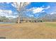 View of the house from the backyard with mature trees, open grass and a pool at 240 Sandy Lake Cir, Fayetteville, GA 30214