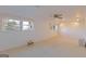 Basement featuring carpeted flooring, two windows, and ceiling fan at 240 Sandy Lake Cir, Fayetteville, GA 30214