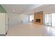 Finished basement featuring a stone fireplace, tile floors, and white refrigerator at 240 Sandy Lake Cir, Fayetteville, GA 30214