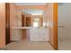 Spacious bathroom featuring a long vanity with cabinets, drawers and a large mirror with bright lighting at 240 Sandy Lake Cir, Fayetteville, GA 30214