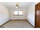 Vacant bedroom featuring neutral-colored walls and carpet, ceiling fan and natural light from the window at 240 Sandy Lake Cir, Fayetteville, GA 30214