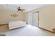 Spacious bedroom with carpet, ceiling fan, and sliding door to the deck at 240 Sandy Lake Cir, Fayetteville, GA 30214