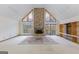 Bright and airy living room featuring vaulted ceilings, a stone fireplace, and access to an outdoor deck at 240 Sandy Lake Cir, Fayetteville, GA 30214