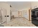 Open-concept kitchen and living space with granite countertops, stainless steel appliances, and spiral staircase access at 240 Sandy Lake Cir, Fayetteville, GA 30214