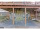 Covered outdoor patio showcasing stone accents, a porch swing, and sliding door access to the home at 240 Sandy Lake Cir, Fayetteville, GA 30214