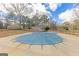 Outdoor pool covered with a safety tarp, nestled in a private backyard setting at 240 Sandy Lake Cir, Fayetteville, GA 30214