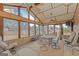 Bright sunroom with multiple windows and a ceiling fan creating a cozy atmosphere for relaxation and dining at 240 Sandy Lake Cir, Fayetteville, GA 30214