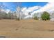 Expansive yard with lush greenery and scattered trees, offering plenty of room for recreation at 240 Sandy Lake Cir, Fayetteville, GA 30214