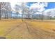 Expansive yard with scattered trees in a park-like setting at 240 Sandy Lake Cir, Fayetteville, GA 30214