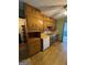 Kitchen features classic wood cabinets, double basin sink, and adjacent open shelving at 3796 Saddle Ridge Dr, Snellville, GA 30039