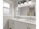 Bright bathroom with a double sink vanity, light gray walls, and a large mirror above the vanity at 2544 Overlook Dr, East Point, GA 30344