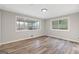 Empty bedroom with light gray walls, wood-look floors, and two large windows at 2544 Overlook Dr, East Point, GA 30344